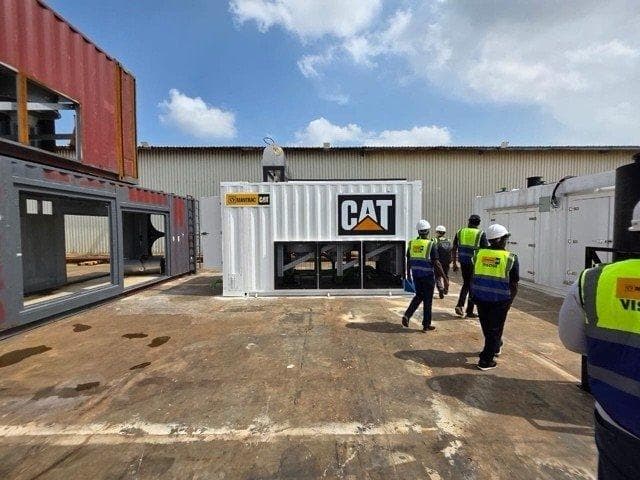 Nigeria partner site: CAT generator container and mining containers on the yard